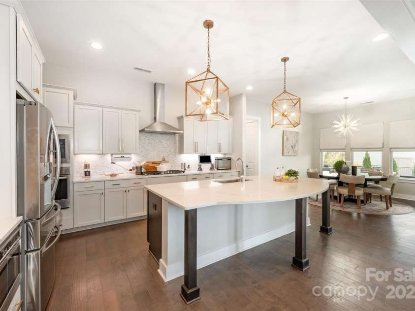 2332 Paddlers Cove Drive, Clover, SC 29710.  MLS# CAR4242429, YatesRealty ID 25958. Oversized island in chef's kitchen, gas cooktop, wall over, undercounter microwave, designer pendants!