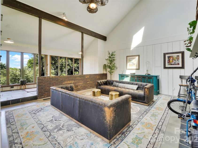 100 Ballantree Drive, Asheville, NC 28803.  MLS# CAR4277967, YatesRealty ID 25963. Wall of Windows Overlooking the Blue Ridge Mountains