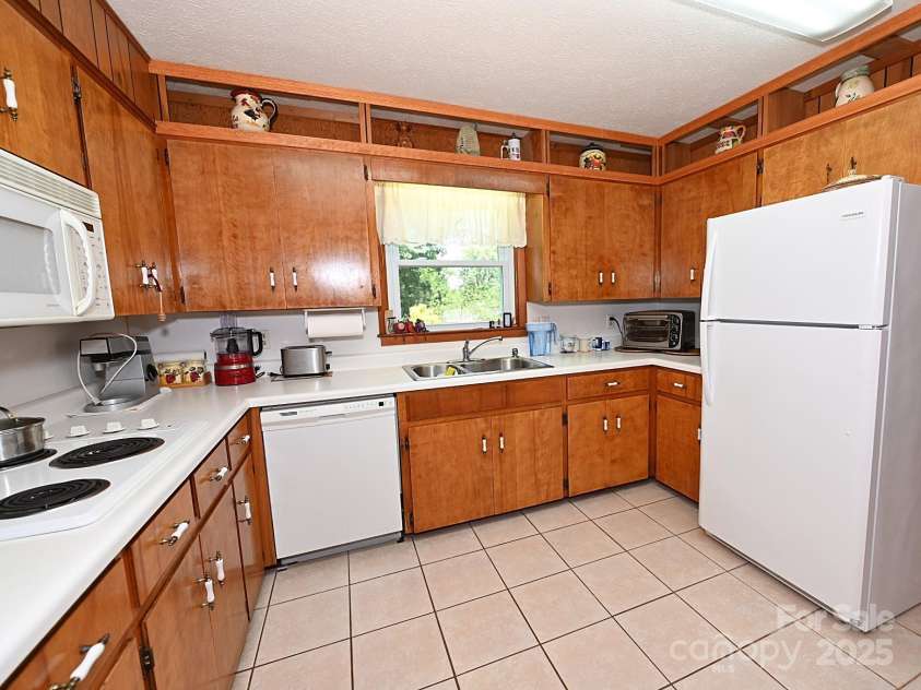 209 Northwood Drive, Morganton, NC 28655.  MLS# CAR4280216, YatesRealty ID 25981. Kitchen offers plenty of counter space and cabinetry. Appliances convey.