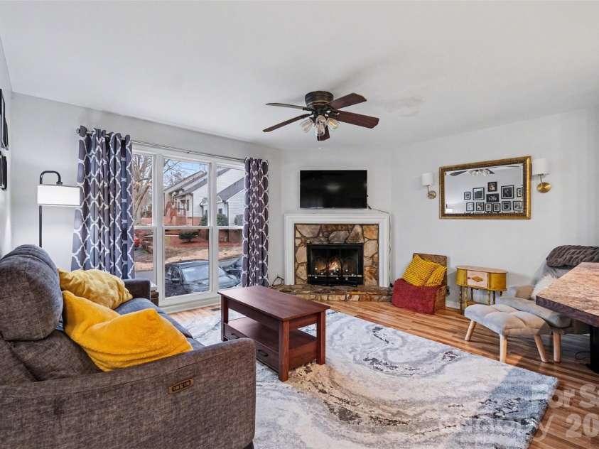 3240 Carlyle Drive, Concord, NC 28027.  MLS# CAR4348837, YatesRealty ID 25988. Living Room with wood burning fireplace