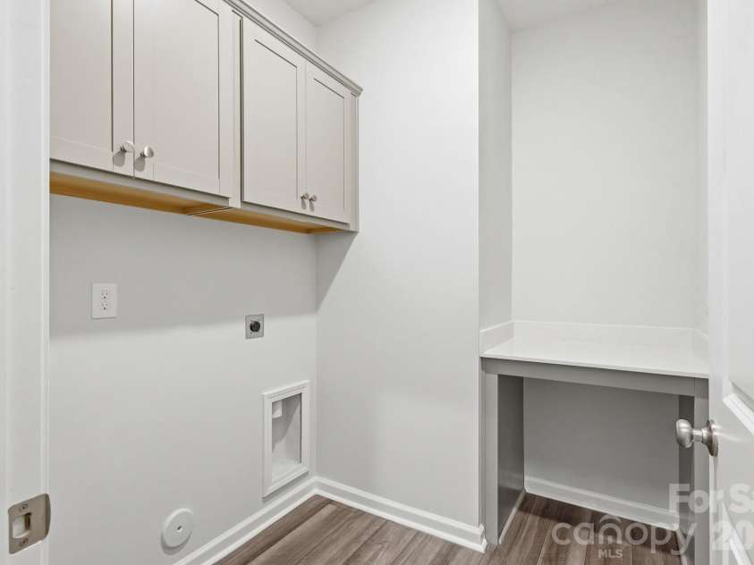223 Rodeo Drive, Shelby, NC 28150.  MLS# CAR4369805, YatesRealty ID 26002. Laundry area with cabinets and folding table