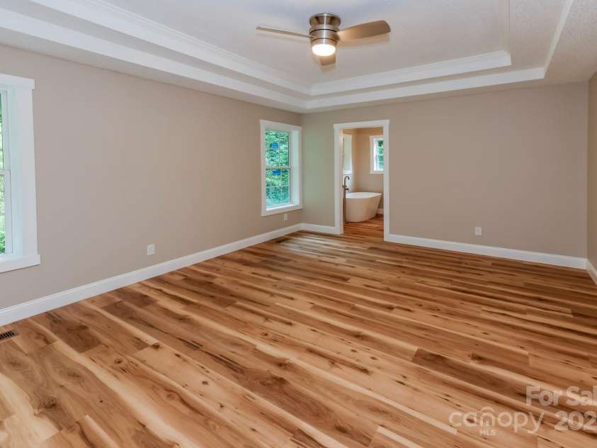 402 Sweetbriar Road, Lake Lure, NC 28746.  MLS# CAR4281606, YatesRealty ID 26005. Main level primary bedroom