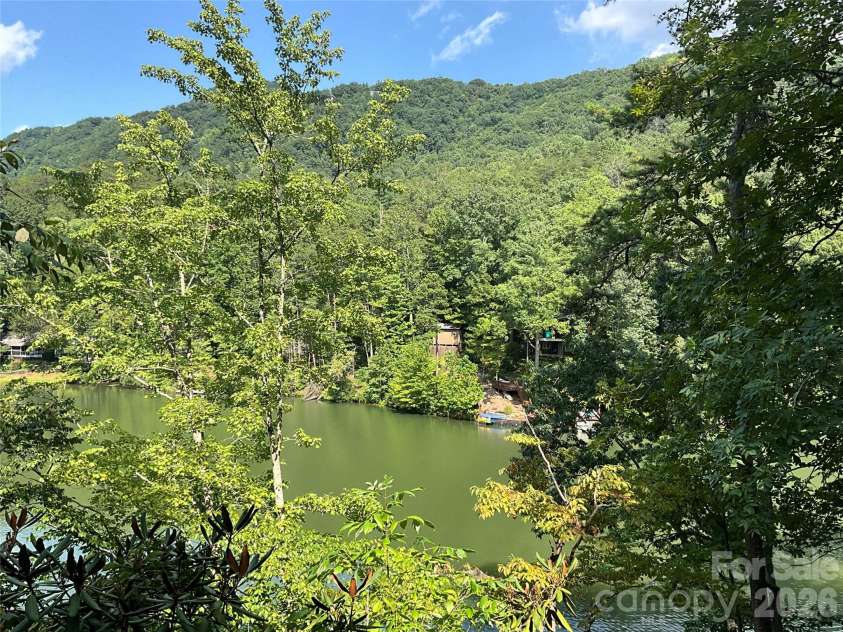222 West Lake Drive, Lake Lure, NC 28746.  MLS# CAR4294335, YatesRealty ID 2601. Water view in the summer