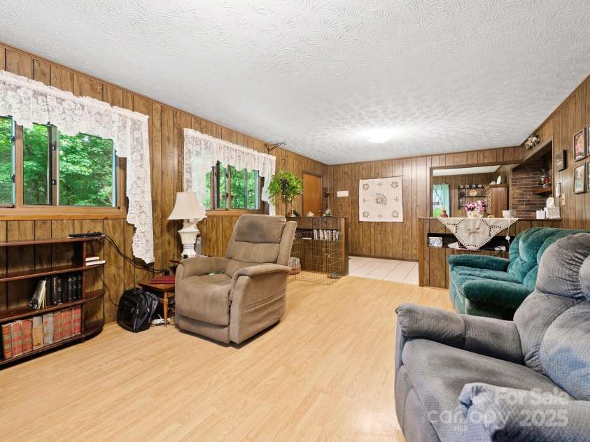 1400 Watershed Road, Mars Hill, NC 28754.  MLS# CAR4280588, YatesRealty ID 26016. Living room looking towards front door downstairs.