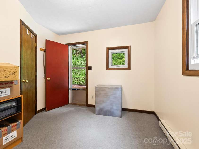 1400 Watershed Road, Mars Hill, NC 28754.  MLS# CAR4280588, YatesRealty ID 26016. This is a multi purpose room leading out to the back deck upstairs. This is a great place for another office or craft/hobby or exercise room. There are so many possibilities with the additional space many homes do not 