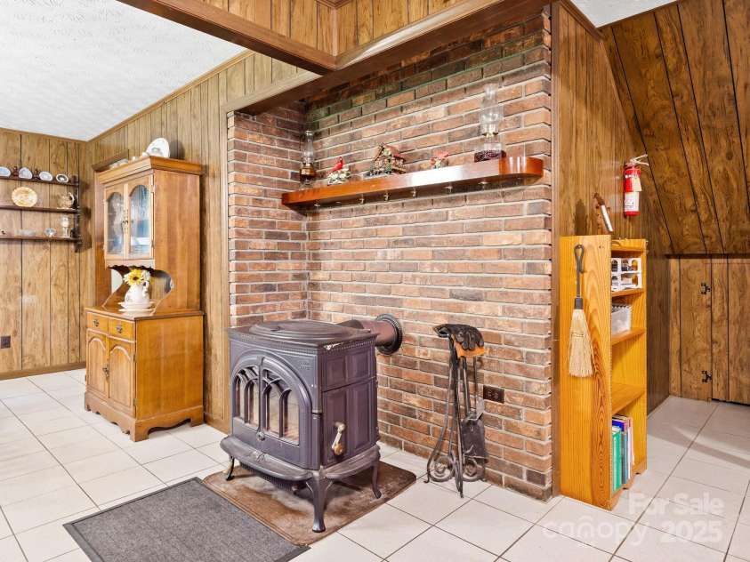 1400 Watershed Road, Mars Hill, NC 28754.  MLS# CAR4280588, YatesRealty ID 26016. This wood stove between dining room and living room keeps this home toasty on cold winter days and nights!