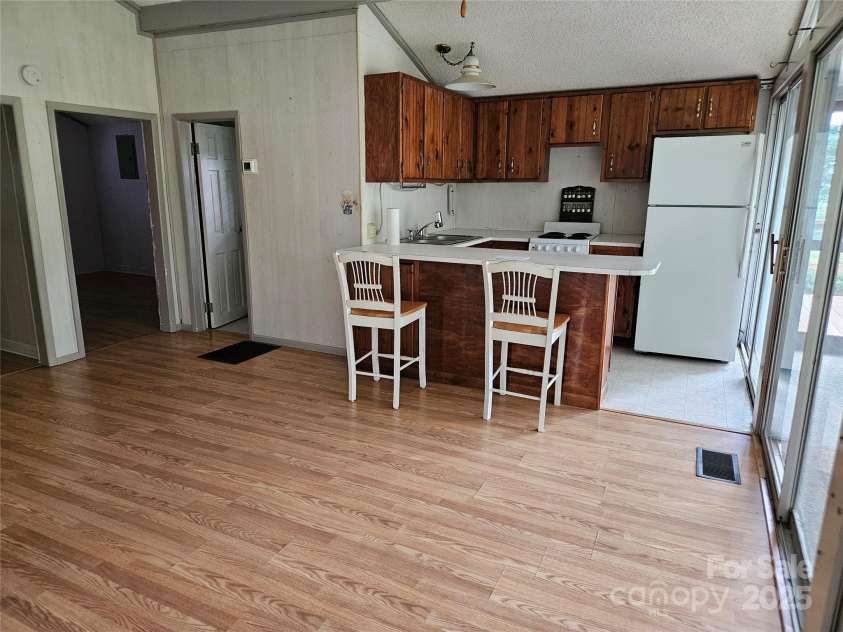 6813 Navajo Trail, Sherrills Ford, NC 28673.  MLS# CAR4253996, YatesRealty ID 26022. Living Room Looking into the Kitchen W/Eat at Bar