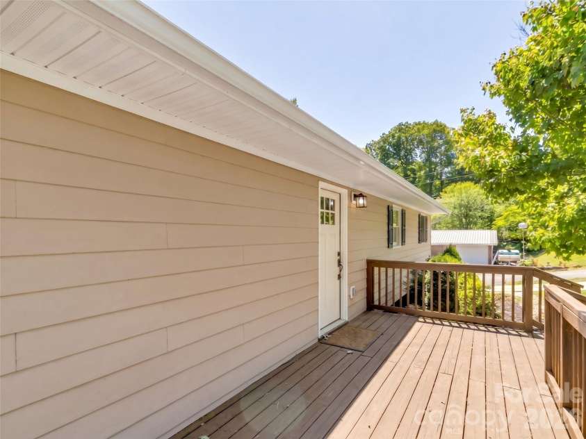 252 Oak Park Drive, Clyde, NC 28721.  MLS# CAR4381377, YatesRealty ID 26039. Door from living room to back deck