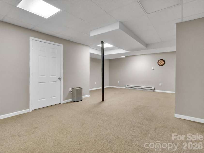 252 Oak Park Drive, Clyde, NC 28721.  MLS# CAR4381377, YatesRealty ID 26039. Lower level family room