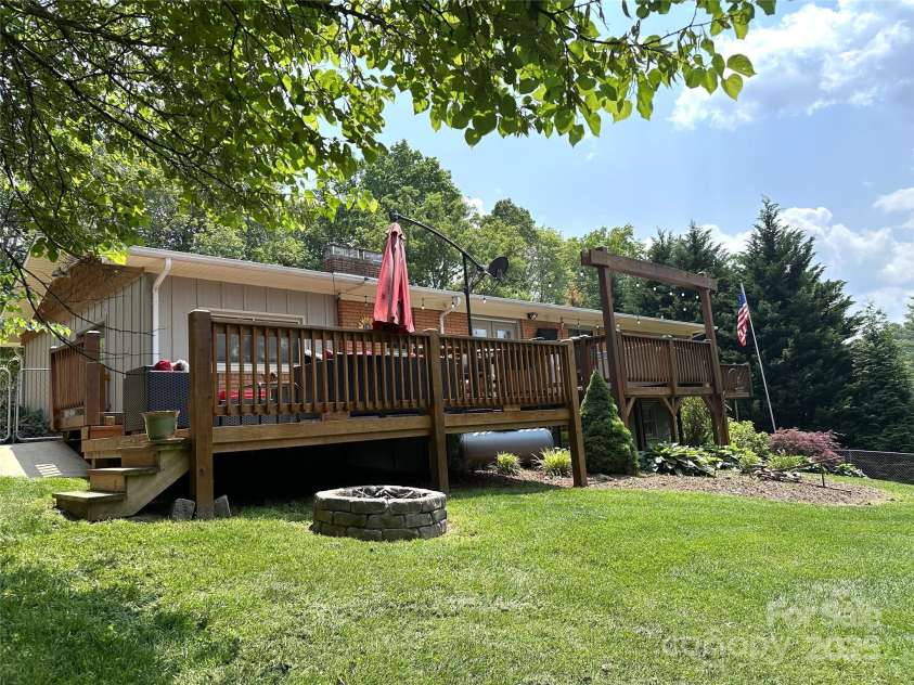 47 Fairlane Drive, Waynesville, NC 28786.  MLS# CAR4267951, YatesRealty ID 26065. Back Deck with firepit and fenced in back yard