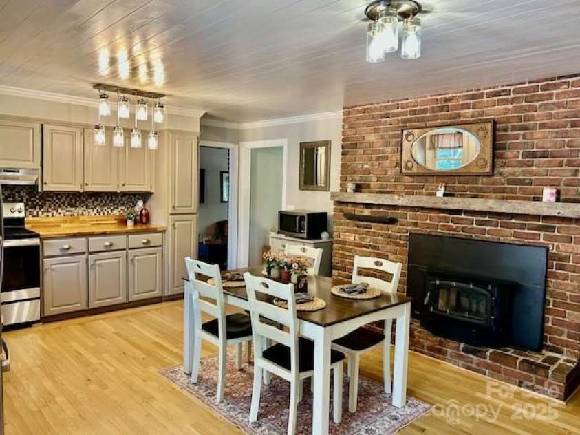47 Fairlane Drive, Waynesville, NC 28786.  MLS# CAR4267951, YatesRealty ID 26065. Kitchen with dining area and Appalachian Wood Stove