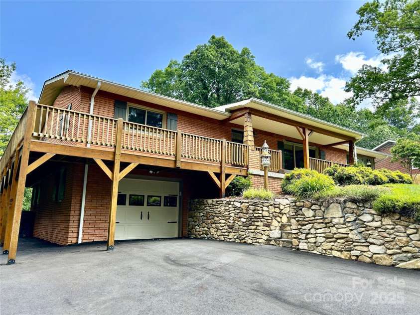 47 Fairlane Drive, Waynesville, NC 28786.  MLS# CAR4267951, YatesRealty ID 26065. Rock Wall with Steps Leading up to Wrap Around Porch