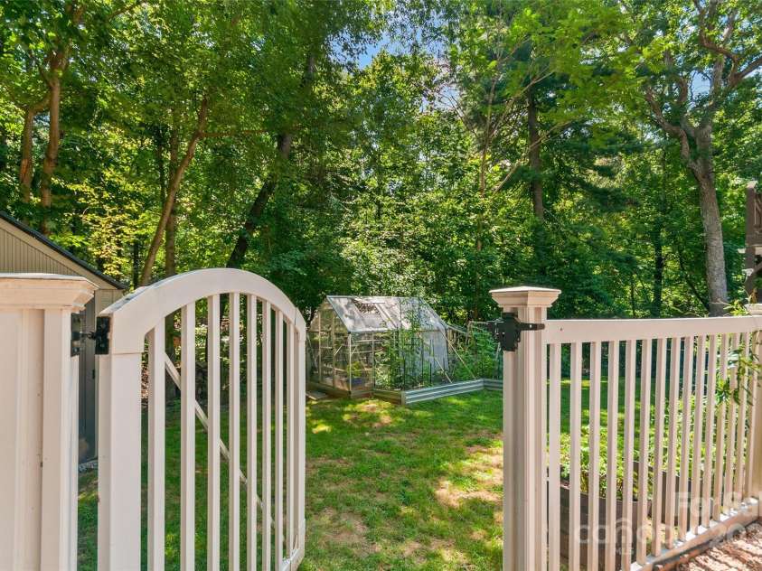 28 Grove Garden Avenue, Candler, NC 28715.  MLS# CAR4278254, YatesRealty ID 26090. Fenced in back yard with green house