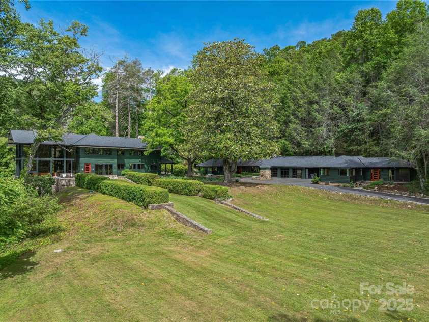 400 Kings Drive, Lake Lure, NC 28746.  MLS# CAR4264882, YatesRealty ID 2612. Neighboring is a heated and cooled 3 car fully finished game room garage and 2 additional guest houses with full kitchens and 2 primary suites each. 