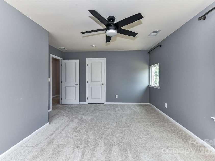 3533 Catherine Creek Place, Davidson, NC 28036.  MLS# CAR4279633, YatesRealty ID 26125. Spacious Bedroom 3 on upper level with ceiling fan/light & great natural light!