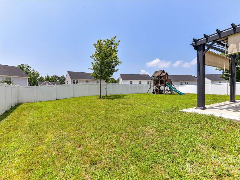 3533 Catherine Creek Place, Davidson, NC 28036.  MLS# CAR4279633, YatesRealty ID 26125. Spacious, fenced, level back yard with covered patio (pergola & playset to remain)!