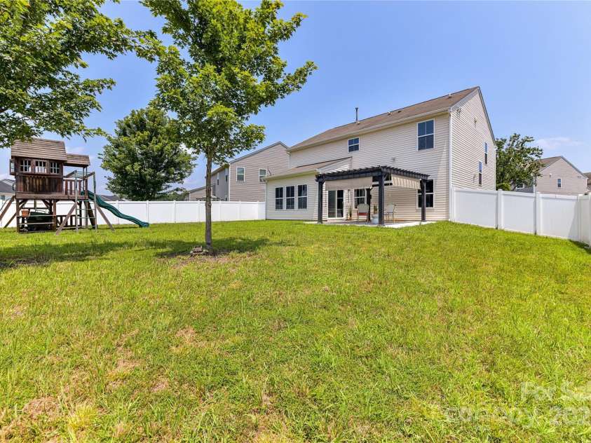 3533 Catherine Creek Place, Davidson, NC 28036.  MLS# CAR4279633, YatesRealty ID 26125. Spacious, fenced, level back yard with covered patio (pergola & playset to remain)!