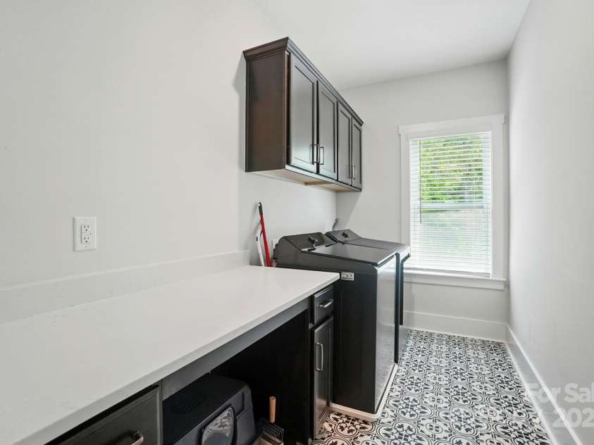 7818 Russell Road, Indian Trail, NC 28079.  MLS# CAR4314616, YatesRealty ID 26129. Laundry room w/folding table