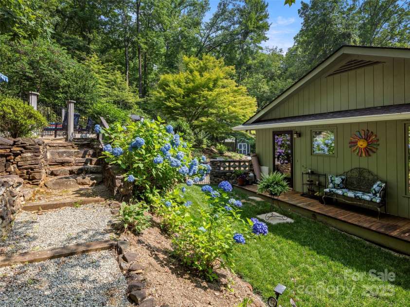 64 Wells Lane, Tryon, NC 28782.  MLS# CAR4277197, YatesRealty ID 26131. Side Courtyard and Steps to the Pool