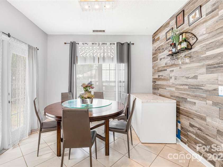 9910 Sandman Lane, Charlotte, NC 28216.  MLS# CAR4278262, YatesRealty ID 26141. Ancient wall as since been removed.