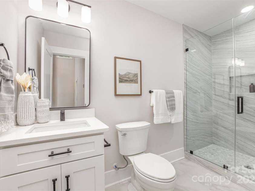 9527 Walkers Ferry Road, Charlotte, NC 28214.  MLS# CAR4255253, YatesRealty ID 26145. Tile surround walk-in shower on first floor bathroom