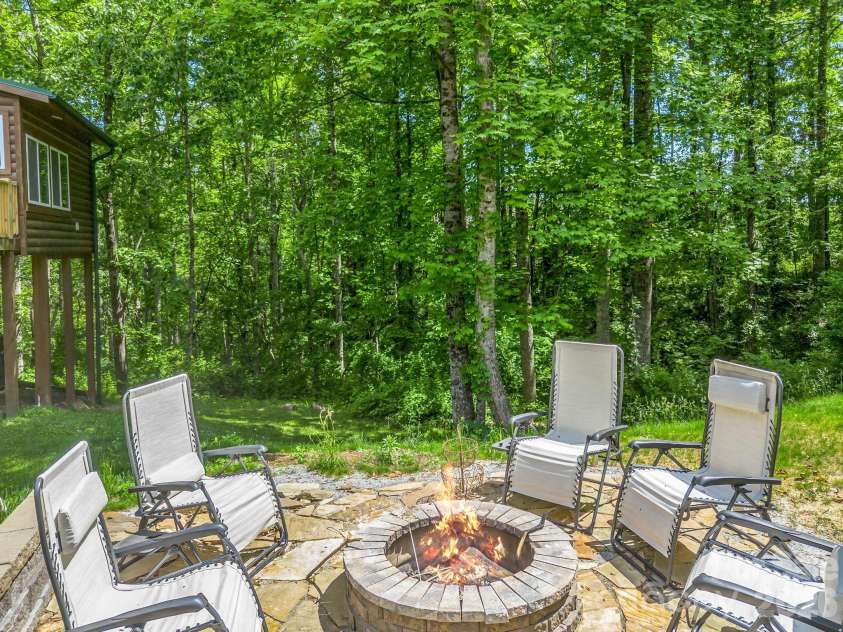 165 Dream Road, Hendersonville, NC 28792.  MLS# CAR4383909, YatesRealty ID 26155. Stone firepit with space for entertaining guests!