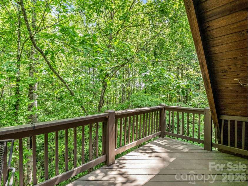 165 Dream Road, Hendersonville, NC 28792.  MLS# CAR4383909, YatesRealty ID 26155. The upper deck offers a charming treehouse-like feel surrounded by nature.