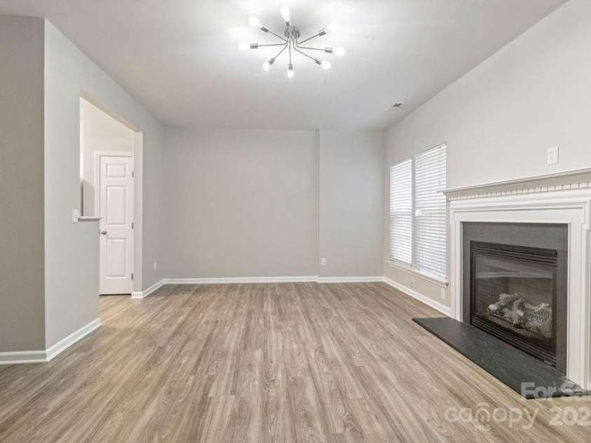 12207 Jessica Place, Charlotte, NC 28269.  MLS# CAR4235868, YatesRealty ID 26157. Living room with gas fireplace