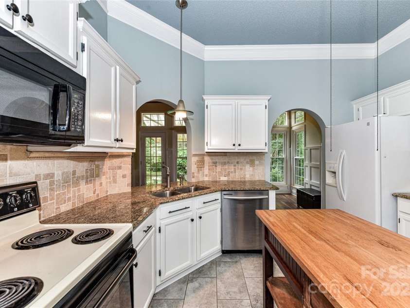 10213 Conistan Place, Cornelius, NC 28031.  MLS# CAR4223056, YatesRealty ID 26169. Kitchen has granite countertops and a pretty arched doorway to the Dining Room