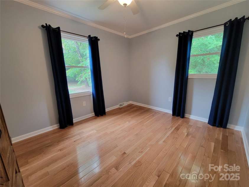 854 Silver Fox Drive, Concord, NC 28025.  MLS# CAR4251256, YatesRealty ID 26171. Bedroom #3. two windows and hardwood floors. Allergens can be avoided.