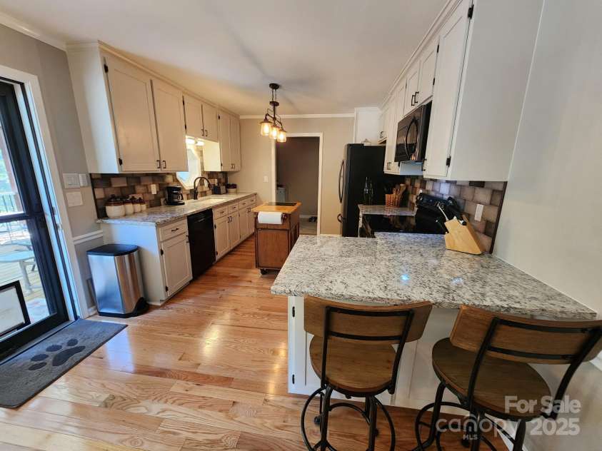 854 Silver Fox Drive, Concord, NC 28025.  MLS# CAR4251256, YatesRealty ID 26171. Peninsula across from screened porch door.