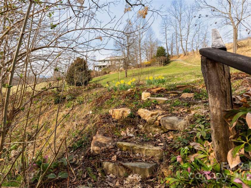 1510 Graham Road, Marshall, NC 28753.  MLS# CAR4241264, YatesRealty ID 26172. Intentional flower planting for year around blooms