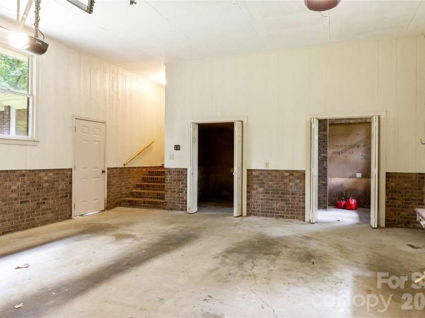2038 Skyway Drive, Monroe, NC 28110.  MLS# CAR4387550, YatesRealty ID 26192. Oversized garage with workshop and storage areas