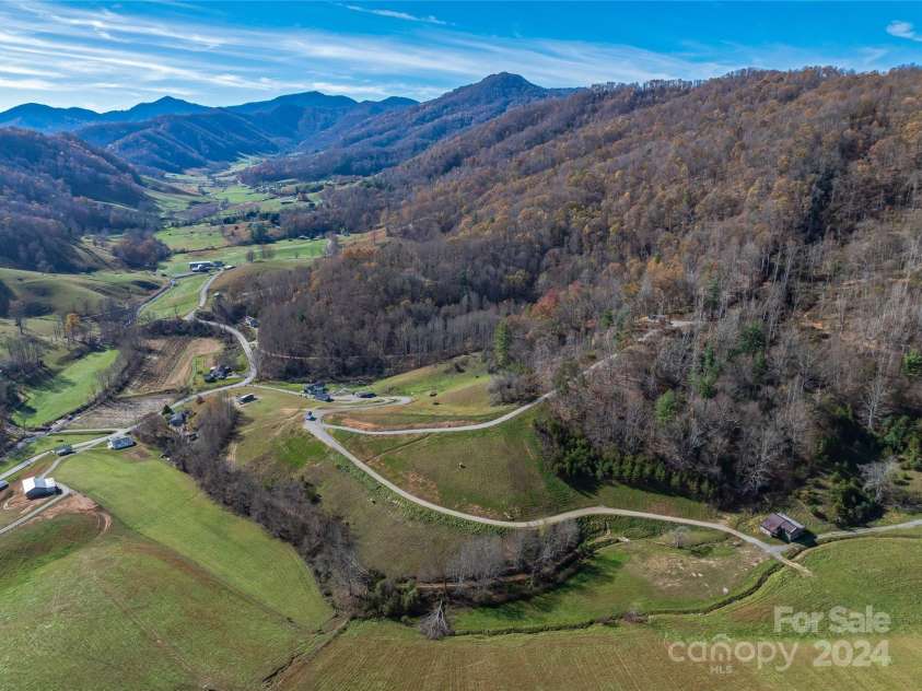 435 N Turkey Creek Road, Leicester, NC 28748.  MLS# CAR4199119, YatesRealty ID 262. Aerial from the east looking down at the property and spying the beautiful valley to the west