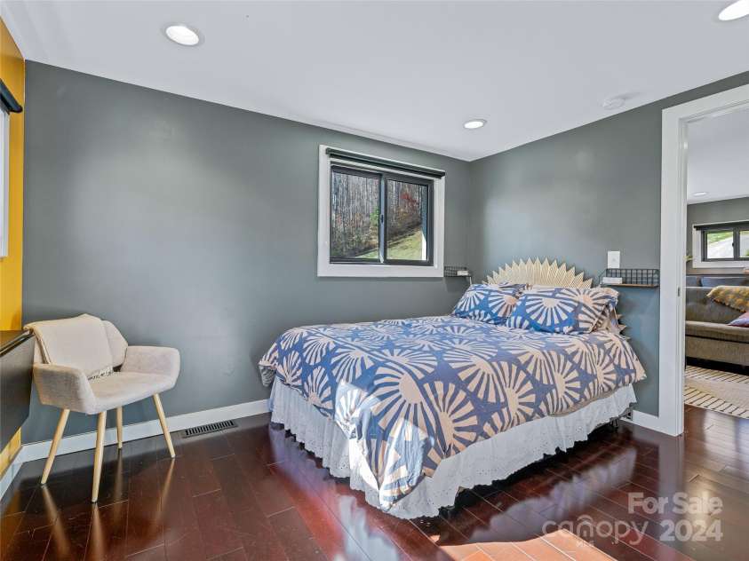 435 N Turkey Creek Road, Leicester, NC 28748.  MLS# CAR4199119, YatesRealty ID 262. The bedroom in the carriage house gets southern exposure and connects to the back deck overlooking the front pasture