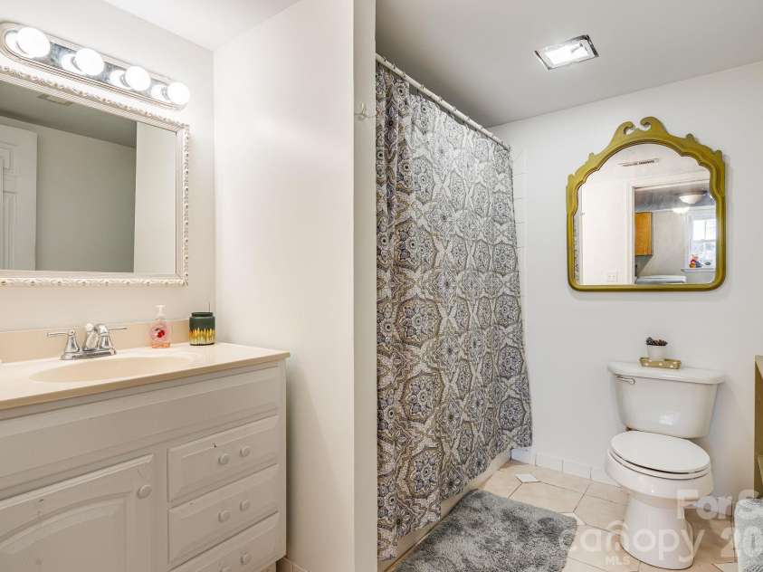 195 Whitmire Road, Brevard, NC 28712.  MLS# CAR4430177, YatesRealty ID 26201. Bathroom on lower level / basement