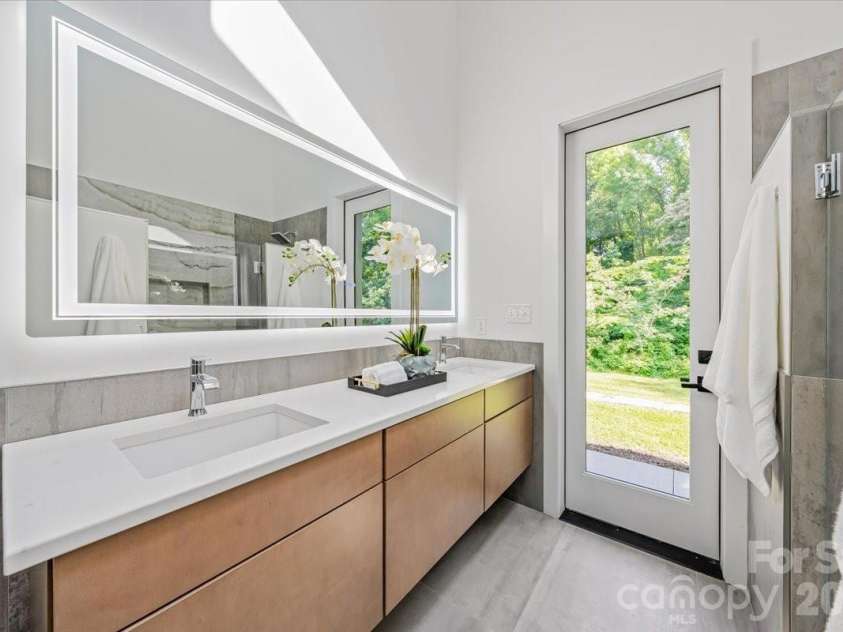 3304 Mar Vista Circle, Charlotte, NC 28209.  MLS# CAR4383686, YatesRealty ID 26245. Primary bath with floating vanity and backlit mirror