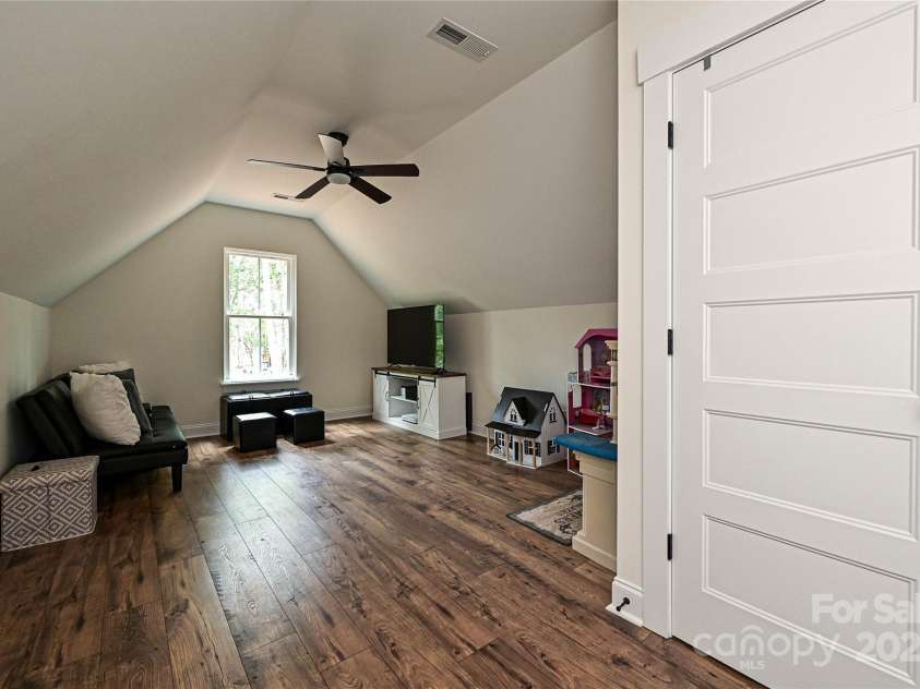 3020 Quiet Lane, Iron Station, NC 28080.  MLS# CAR4259783, YatesRealty ID 26247. This 4th Bedroom has beautiful flooring, vaulted ceilings, neutral pain along with a stylish ceiling fan.  There are unlimited possibilities!  Bedroom - Office - Home Gym - Play Room - Craft Room....you name it!