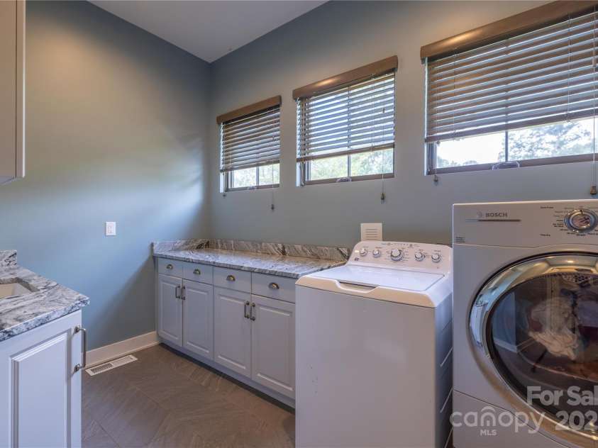 65 Wandering Oaks Way, Asheville, NC 28805.  MLS# CAR4267136, YatesRealty ID 26255. Deluxe main level laundry with sink