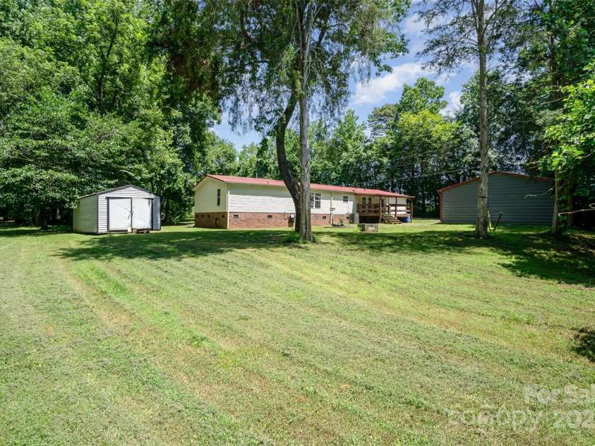 495 Brumley Road, Mooresville, NC 28115.  MLS# CAR4272935, YatesRealty ID 26284. Back of house by Cow pasture opening