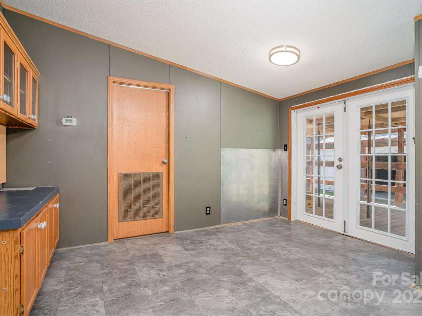 495 Brumley Road, Mooresville, NC 28115.  MLS# CAR4272935, YatesRealty ID 26284. Kitchen and back room (closed door is laundry room with half bath)