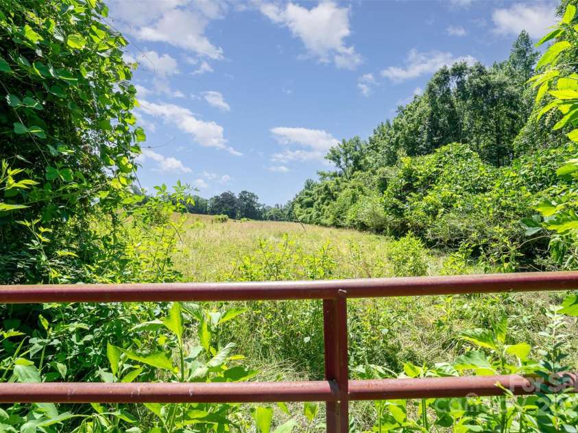 495 Brumley Road, Mooresville, NC 28115.  MLS# CAR4272935, YatesRealty ID 26284. Looking into Cow Pasture that buts up to back of property
