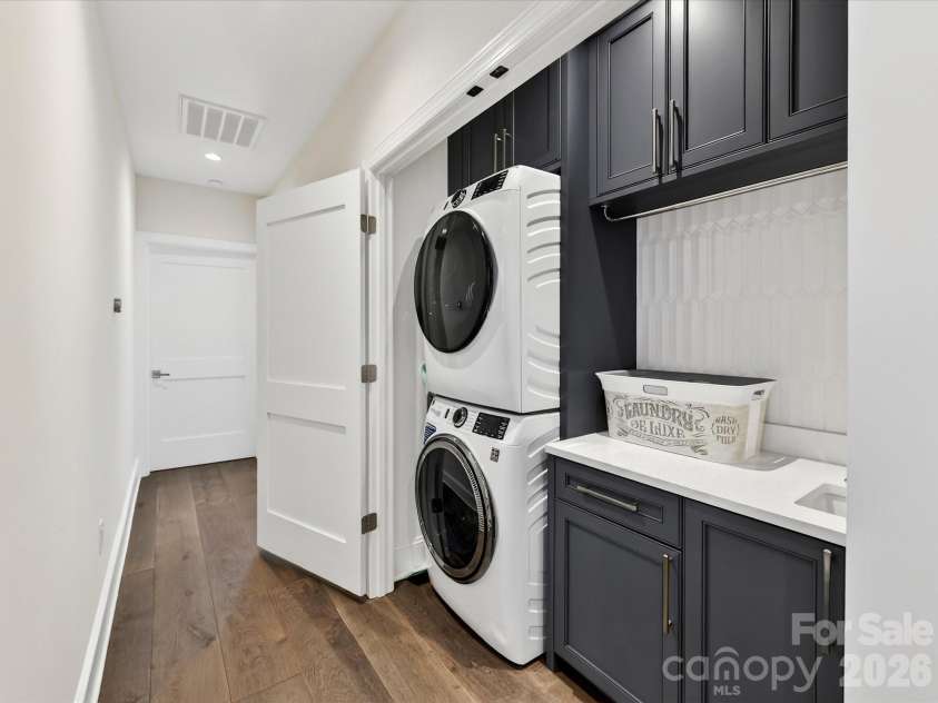 3074 Selwyn Avenue, Charlotte, NC 28209.  MLS# CAR4366300, YatesRealty ID 26301. Laundry with custom cabinetry and sink