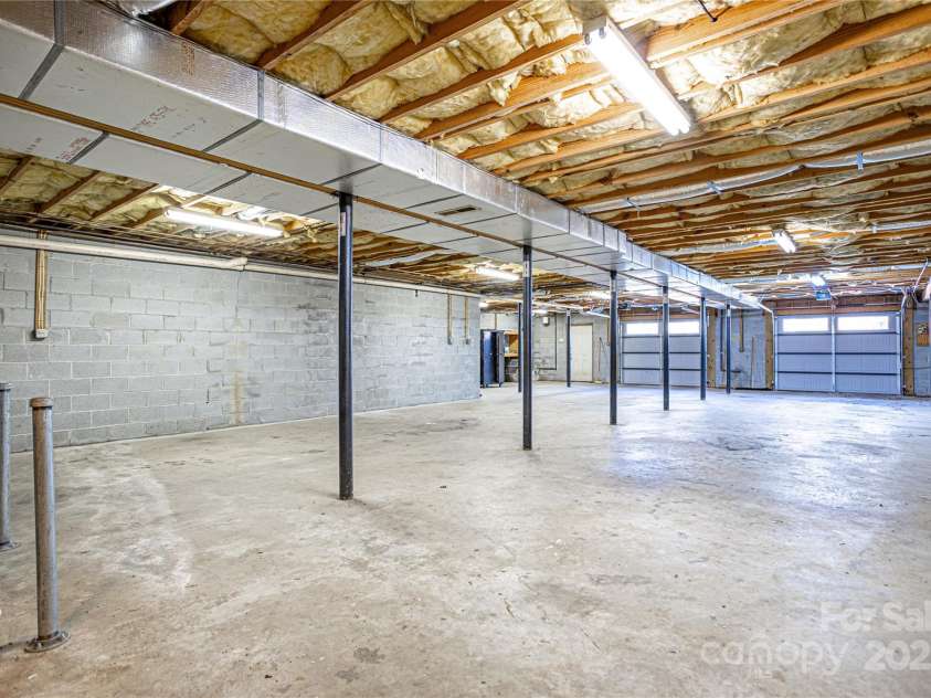 35 Tree Top Drive, Arden, NC 28704.  MLS# CAR4237850, YatesRealty ID 26306. 6 car garage with storage shelves
