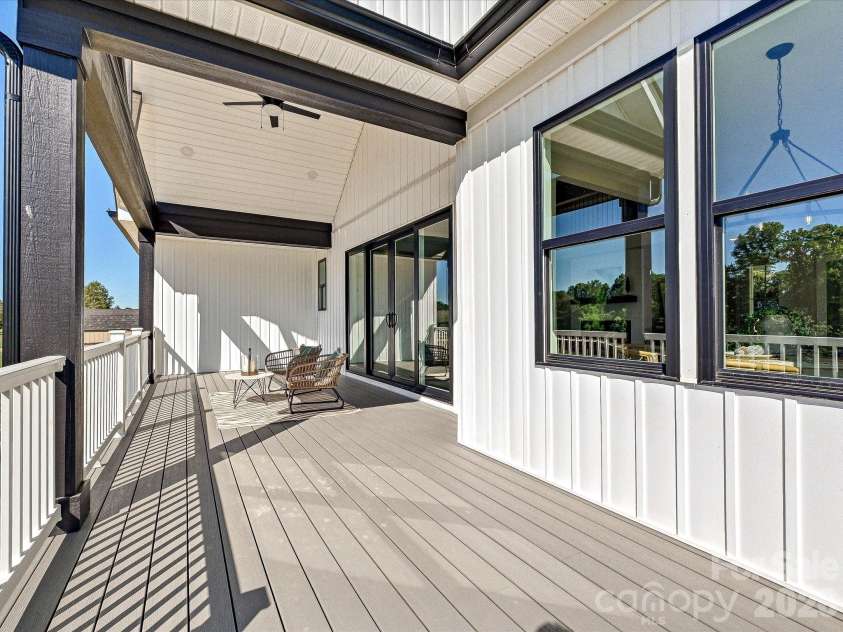 163 Lone Pine Road, Statesville, NC 28625.  MLS# CAR4383652, YatesRealty ID 26311. Covered back deck showcases vaulted wood-accented ceilings, composite decking, and seamless indoor-outdoor living with peaceful wooded views.
