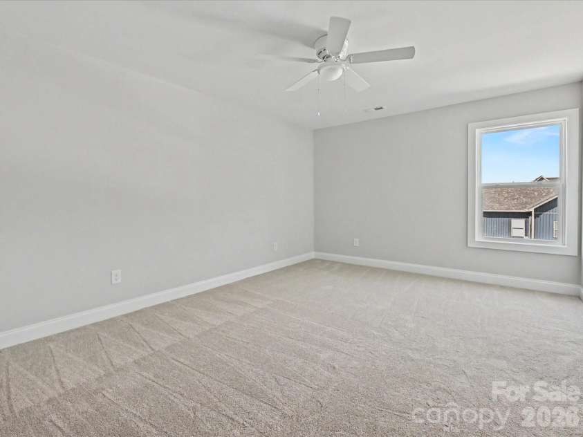 163 Lone Pine Road, Statesville, NC 28625.  MLS# CAR4383652, YatesRealty ID 26311. Generously sized secondary bedroom offers plush carpeting, neutral tones, and versatile space perfect for family, guests, or a home office.