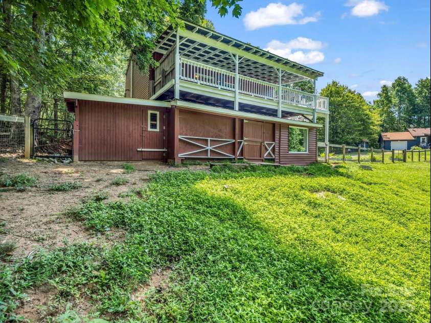 2430 2434 Mountain Page Road, Saluda, NC 28773.  MLS# CAR4276015, YatesRealty ID 26321. Animal shelter on the left, hay and feed storage in the middle