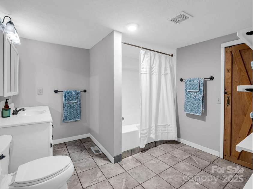 2430 2434 Mountain Page Road, Saluda, NC 28773.  MLS# CAR4276015, YatesRealty ID 26321. Bathroom on the lower level