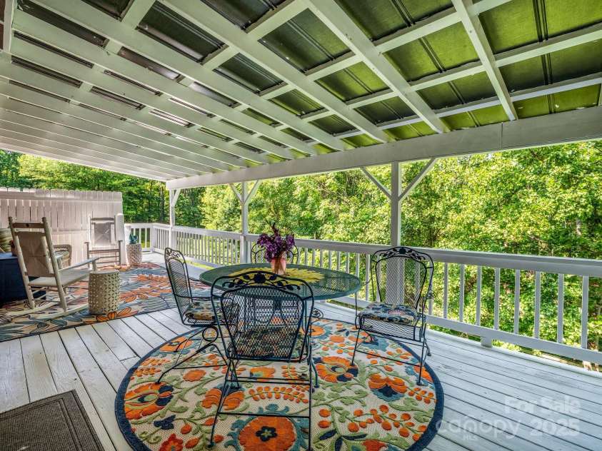 2430 2434 Mountain Page Road, Saluda, NC 28773.  MLS# CAR4276015, YatesRealty ID 26321. Covered deck off of the kitchen overlooks the pasture
