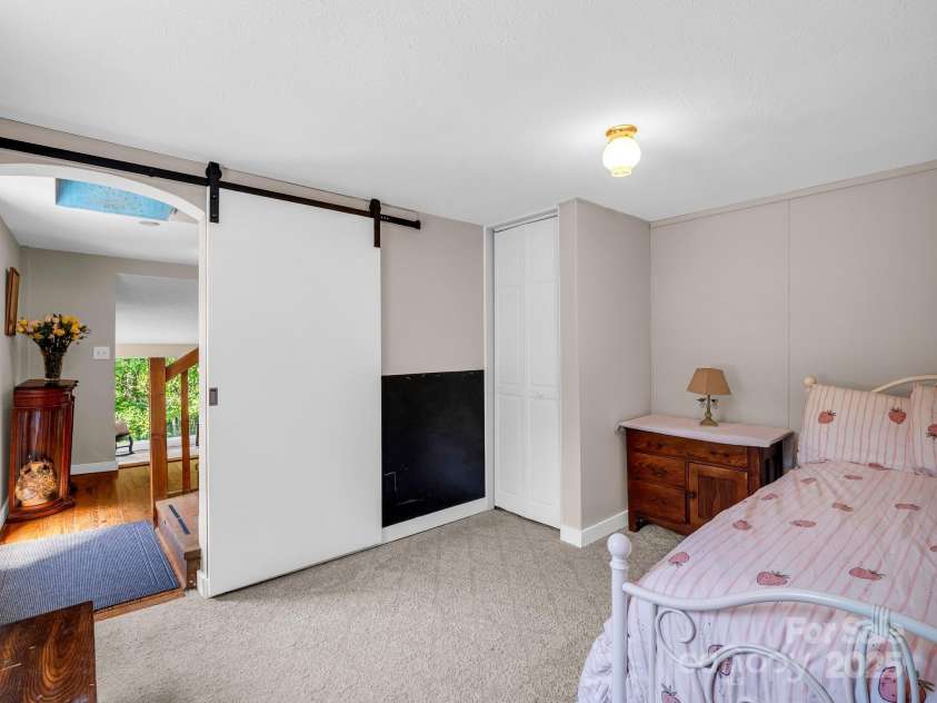 2430 2434 Mountain Page Road, Saluda, NC 28773.  MLS# CAR4276015, YatesRealty ID 26321. Den on the lower level